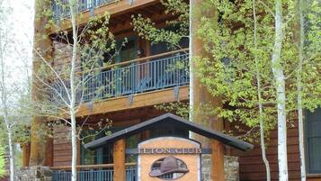A multi-story building with a sign reading "Teton Club Jackson Hole."
