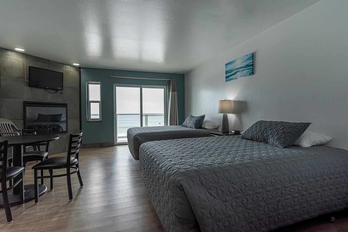 A modern hotel room with a bed, a desk, and a chair.