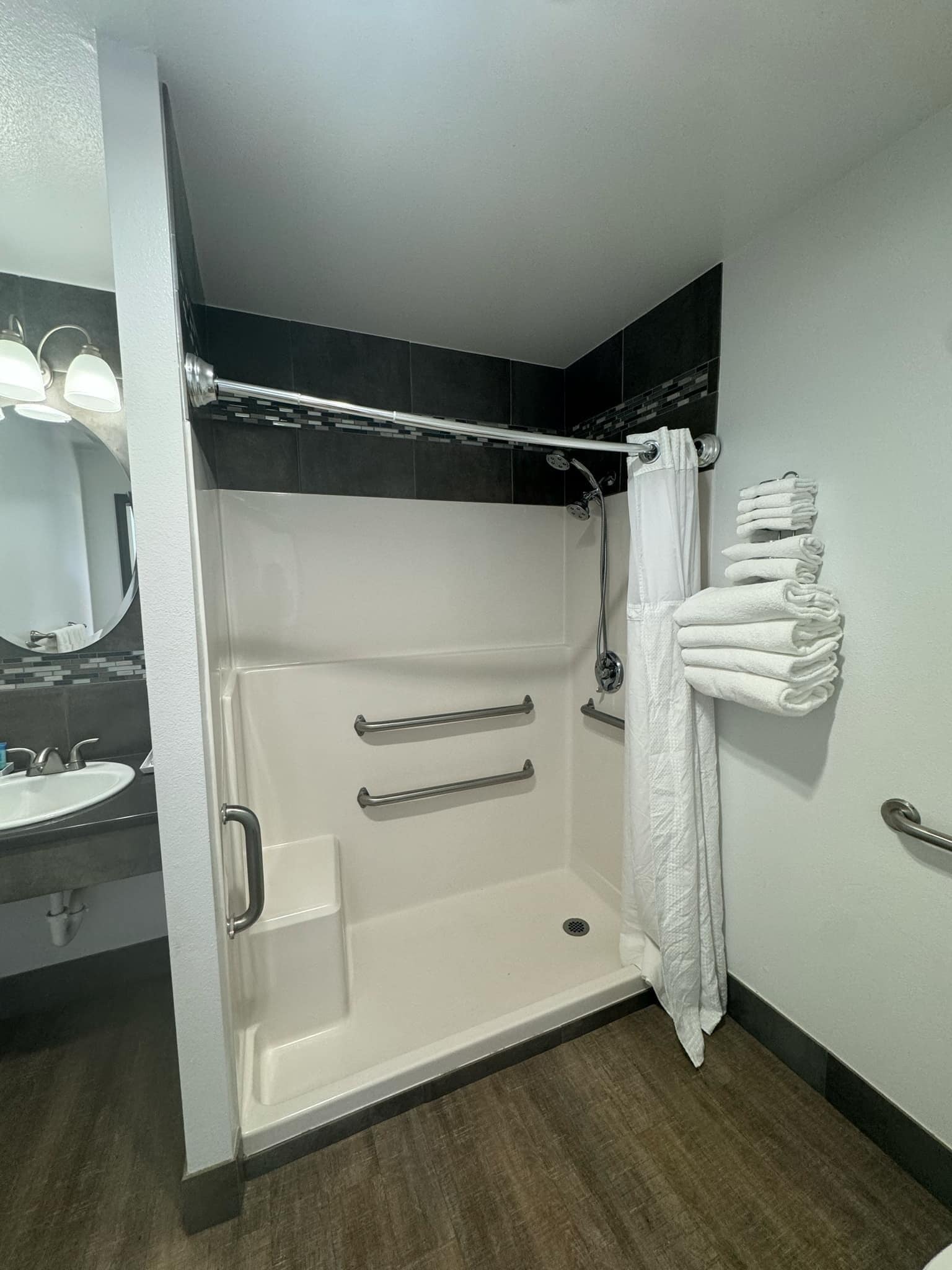A modern bathroom with a walk-in shower, a toilet, and a sink.