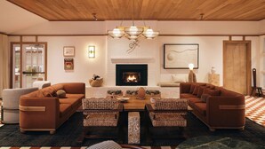 A cozy living room with a fireplace, wooden ceiling, and a checkered floor. - The Beachside (Nantucket)
