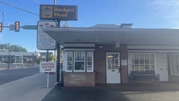 A motel with a sign indicating it is a Budget Host.