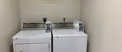 A laundry area with two Whirlpool washers and a sign indicating it is for guest use only.