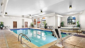 An indoor swimming pool with clear water, a 3-foot depth marker, and a lifeguard stand. - Best Western Grande River Inn & Suites (Clifton)