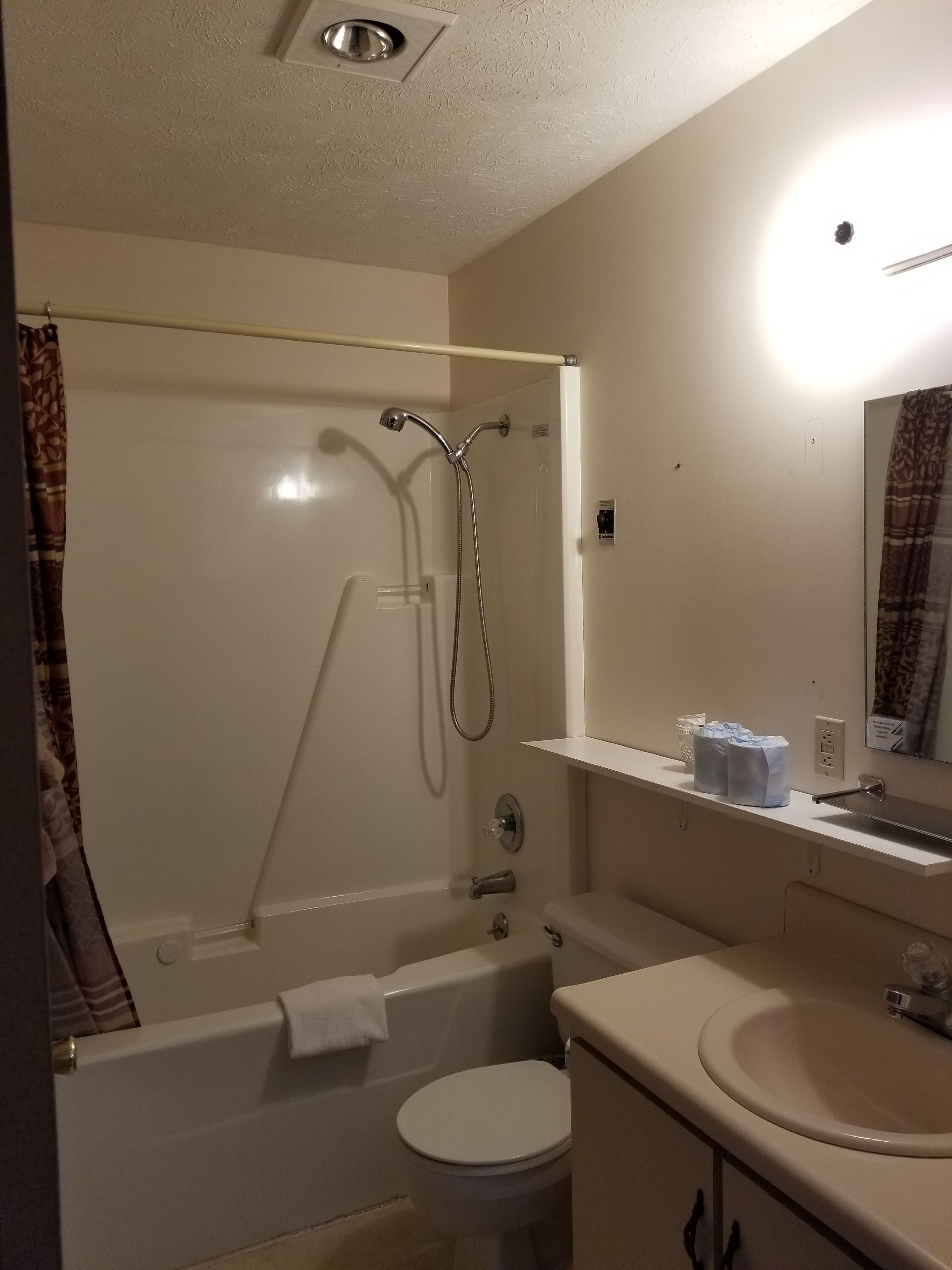 A bathroom with a bathtub, toilet, and sink.