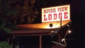 A rustic building with a sign reading "River View Lodge." - Riverview Lodge (Kernville)