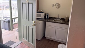 A compact kitchen with a built-in microwave, a sink, and a small countertop. - Lakeshore Lodge (Wofford Heights)