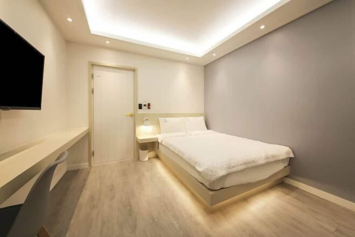 Laptop workspace, blackout drapes, iron/ironing board, bed sheets