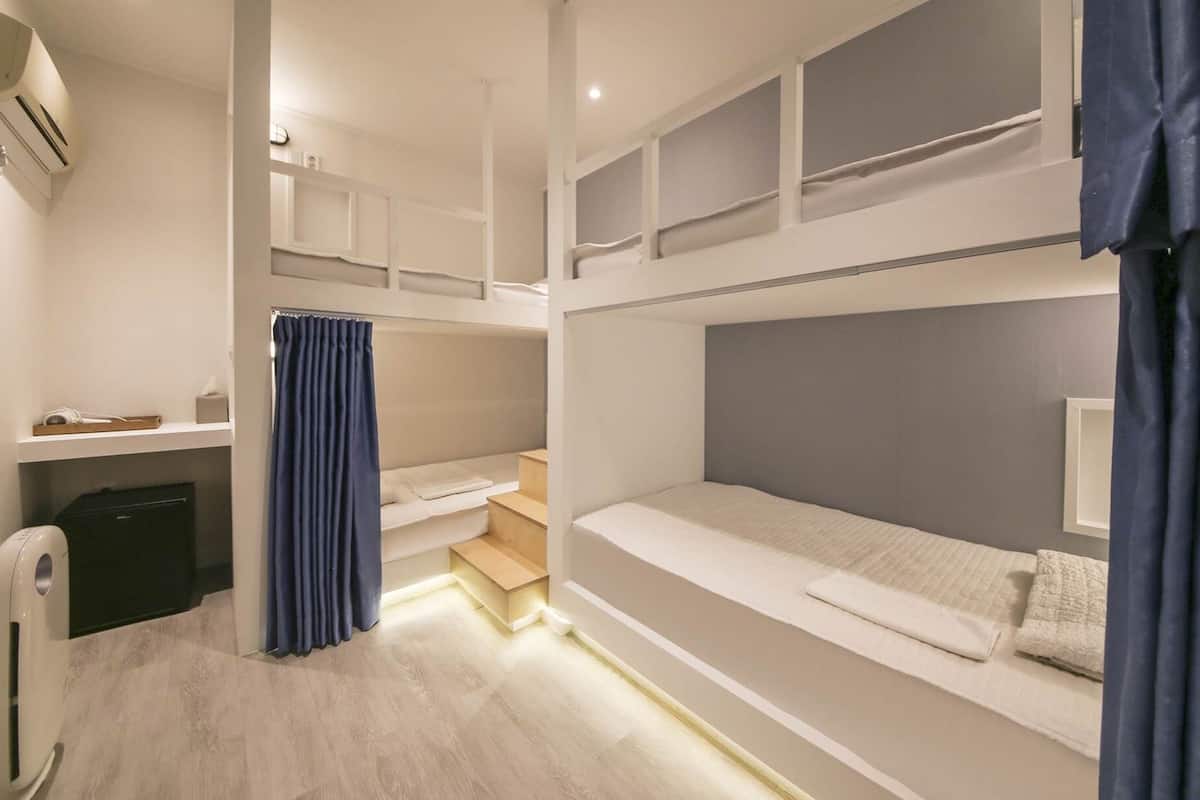 Laptop workspace, blackout drapes, iron/ironing board, bed sheets