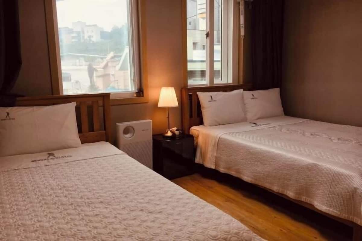 Laptop workspace, blackout drapes, iron/ironing board, bed sheets