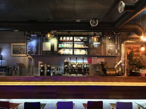 A bar area with a menu board displaying various drink options and prices. - Backpackers in Yeosu - Hostel (Yeosu)