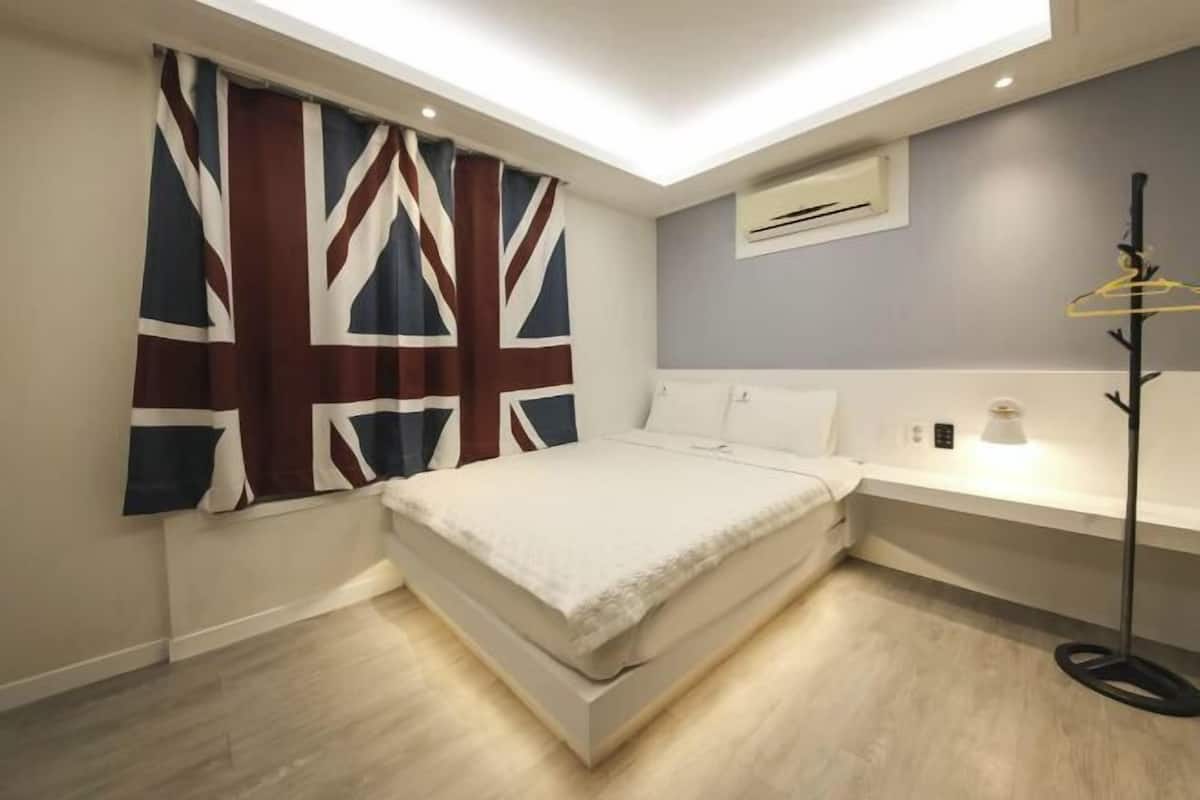 Laptop workspace, blackout drapes, iron/ironing board, bed sheets