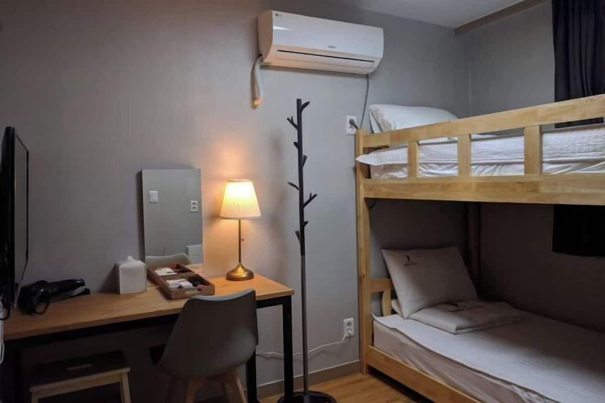 Laptop workspace, blackout drapes, iron/ironing board, bed sheets