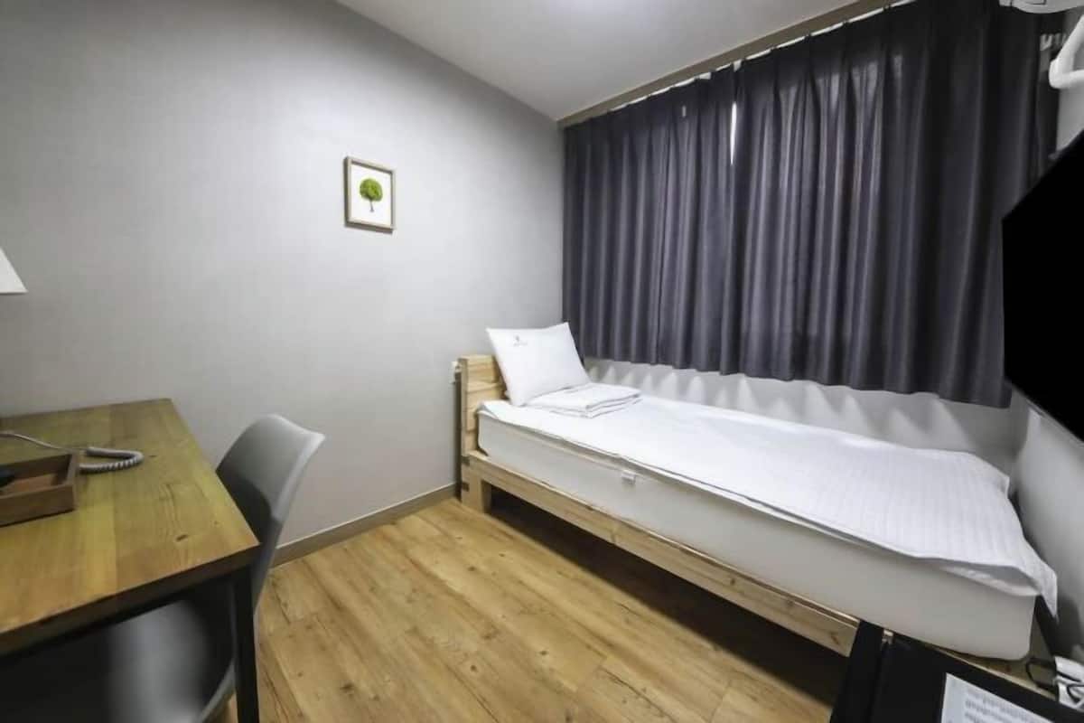 Laptop workspace, blackout drapes, iron/ironing board, bed sheets