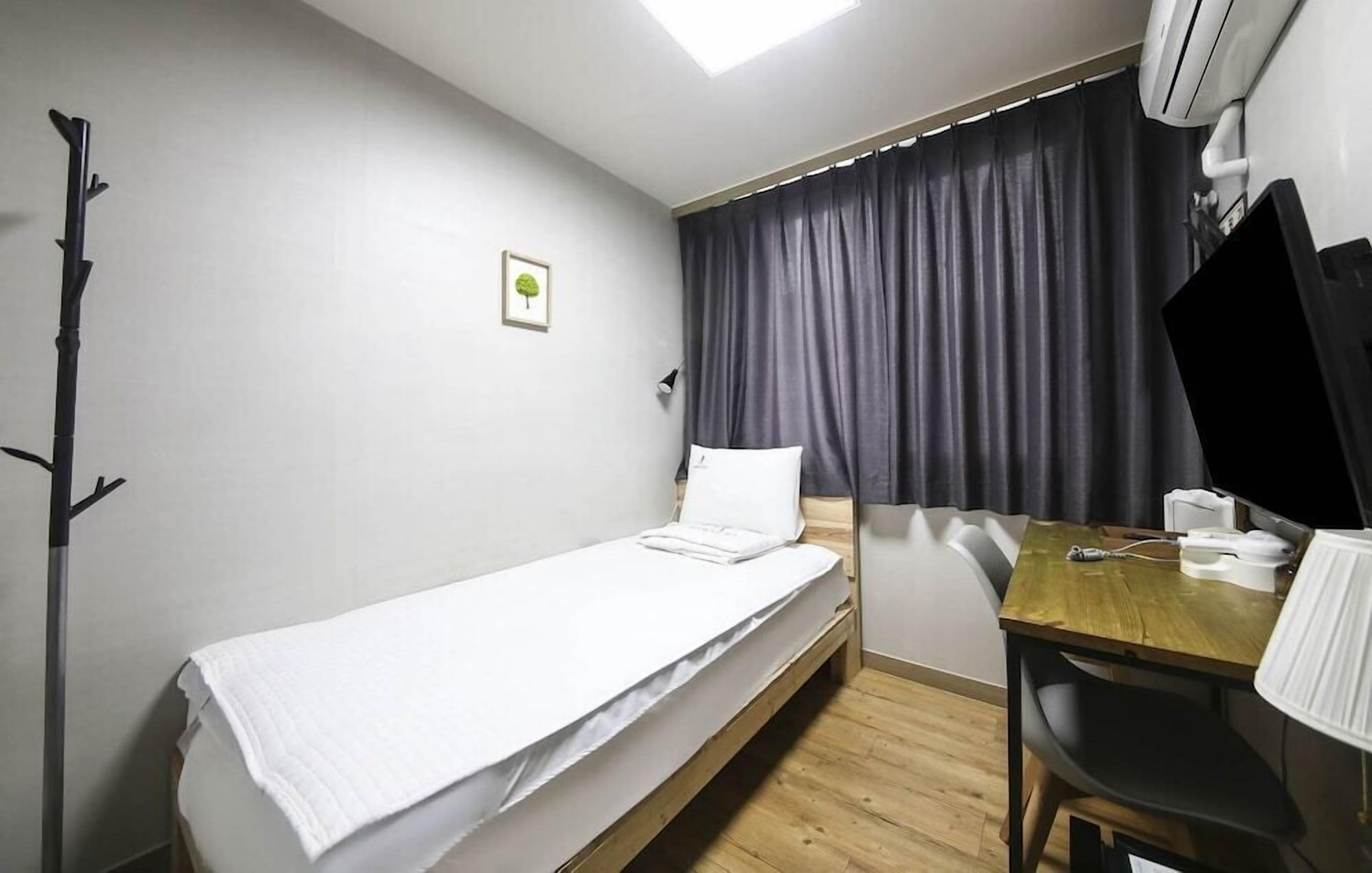 Laptop workspace, blackout drapes, iron/ironing board, bed sheets