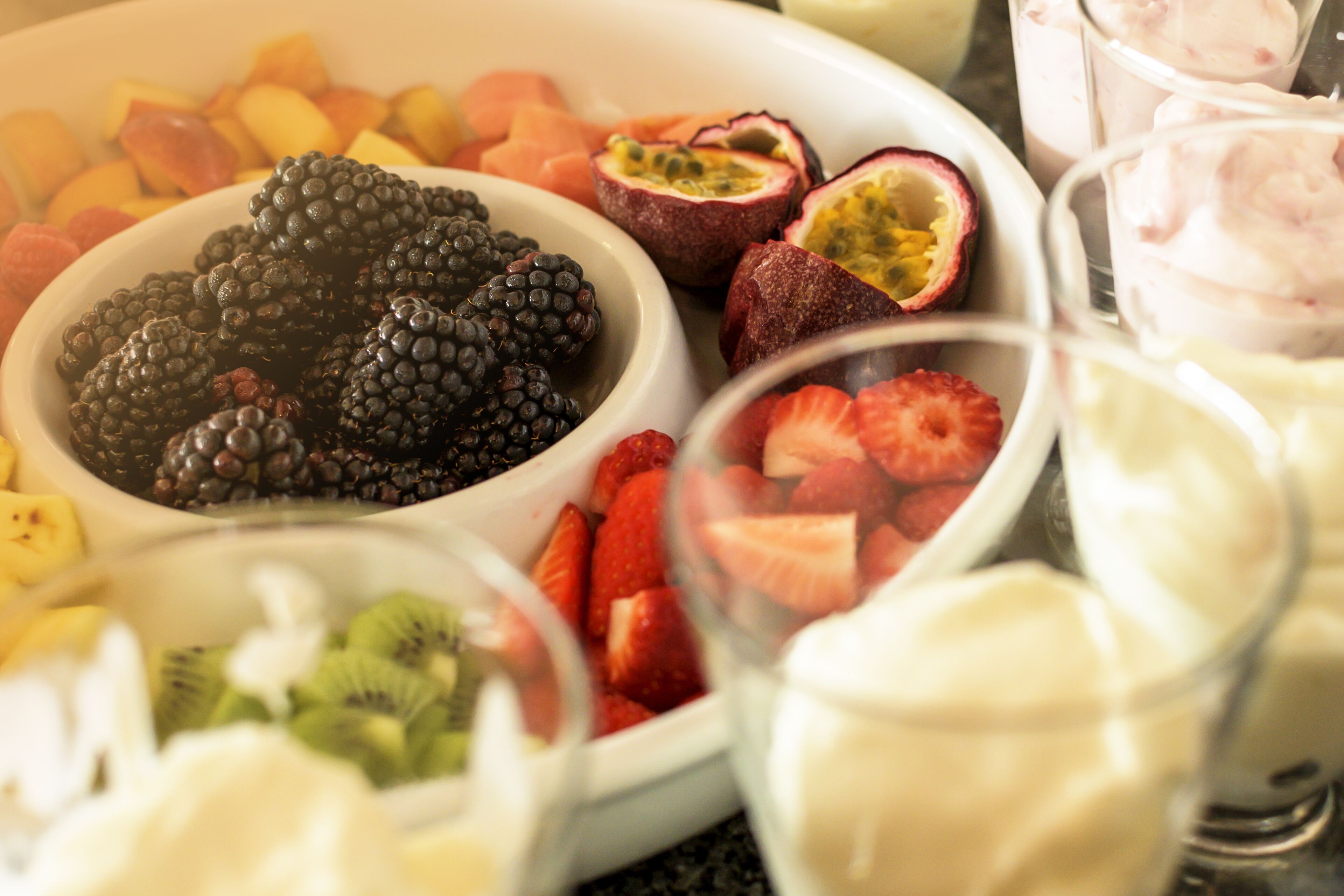 A variety of fruits and desserts on a table.