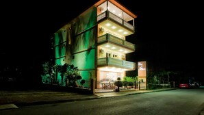 A multi-story hotel with balconies and a well-lit entrance. - Casa Di Mare Poseidon (Katerini)