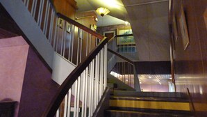 A staircase with wooden railings and a handrail, leading to an upper floor. - Hotel Victor Hugo (Dijon)