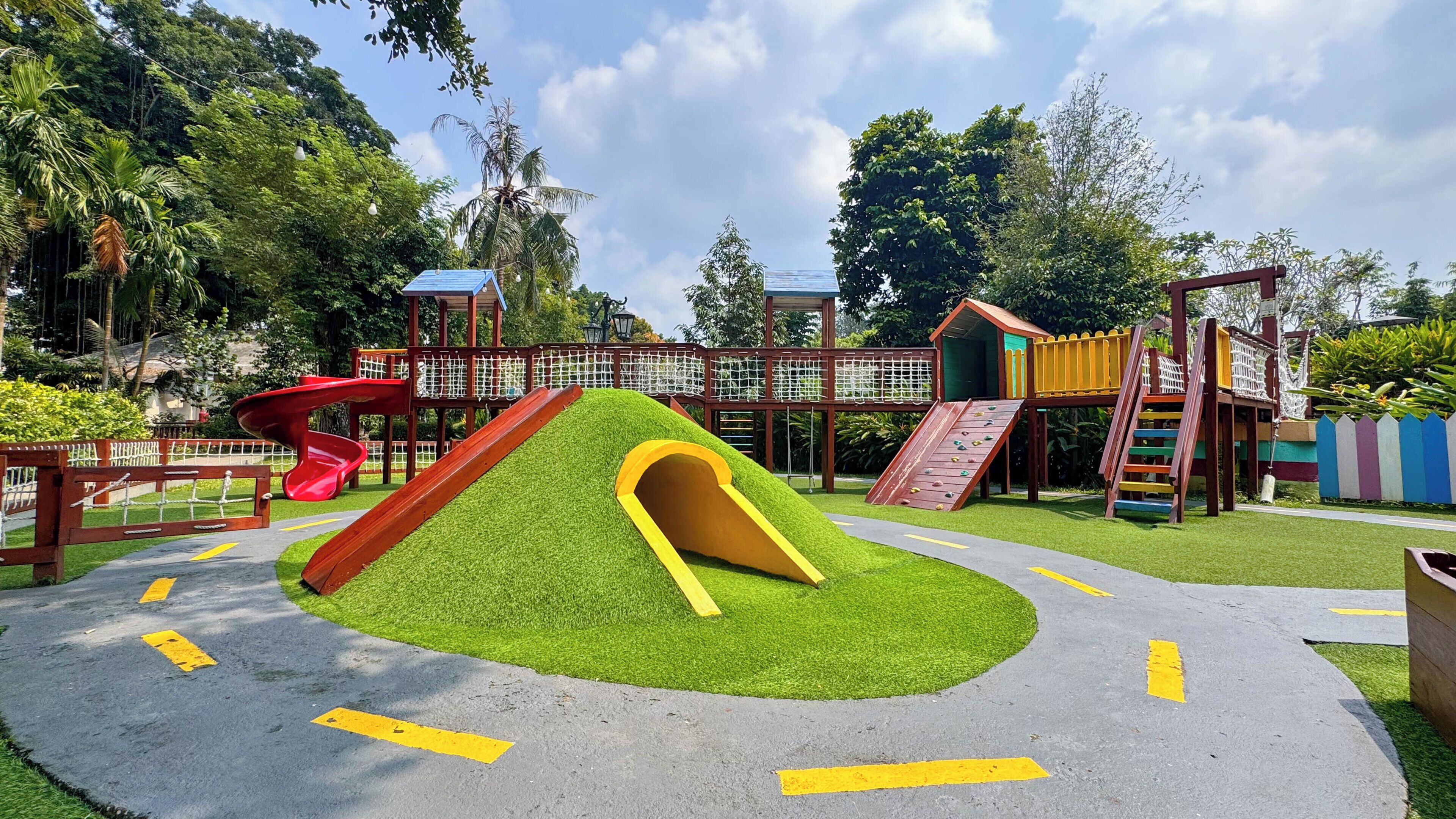 A playground with slides, climbing areas, and a fenced play area.