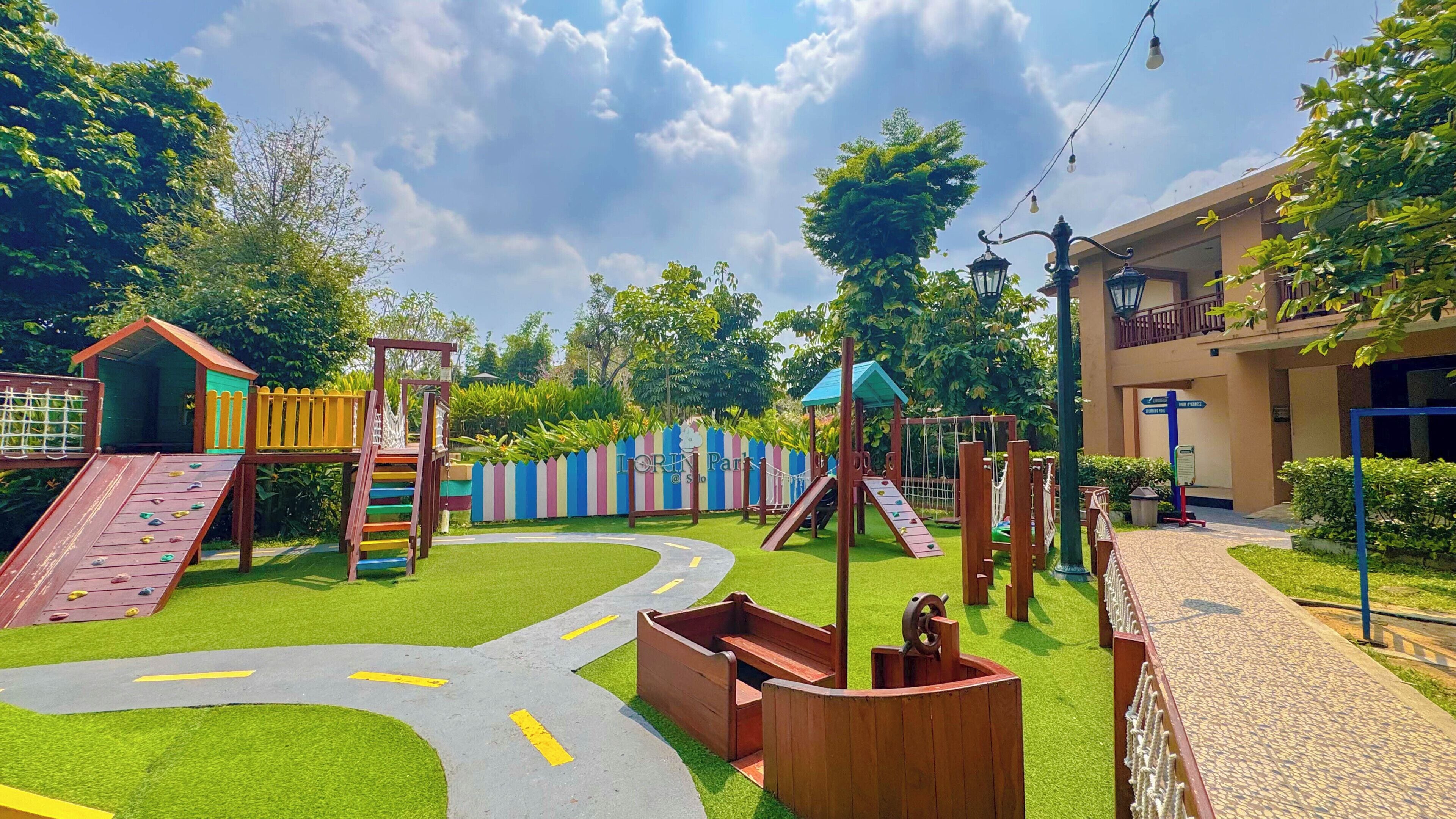 A playground with slides, climbing structures, and a winding path.