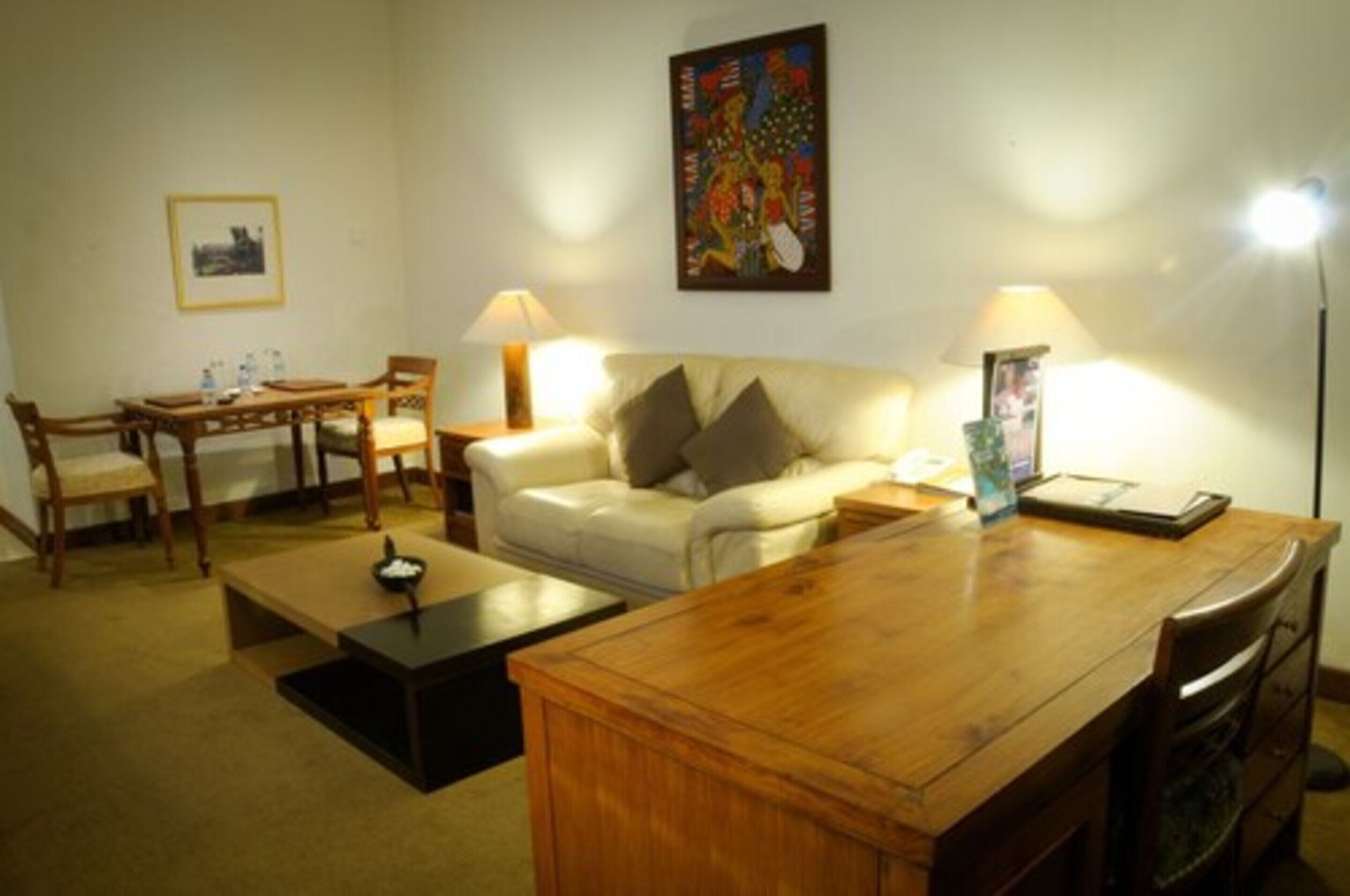 Premium Suite, 1 King Bed | Living room | 32-inch flat-screen TV with cable channels, TV