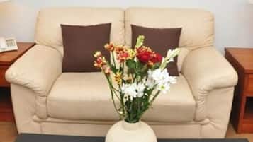 Premium Suite, 1 King Bed | Living area | 32-inch flat-screen TV with cable channels, TV