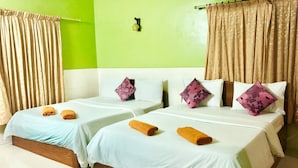 A hotel room with two beds, green walls, and beige curtains. - Jasmine Lodge (Siem Reap)