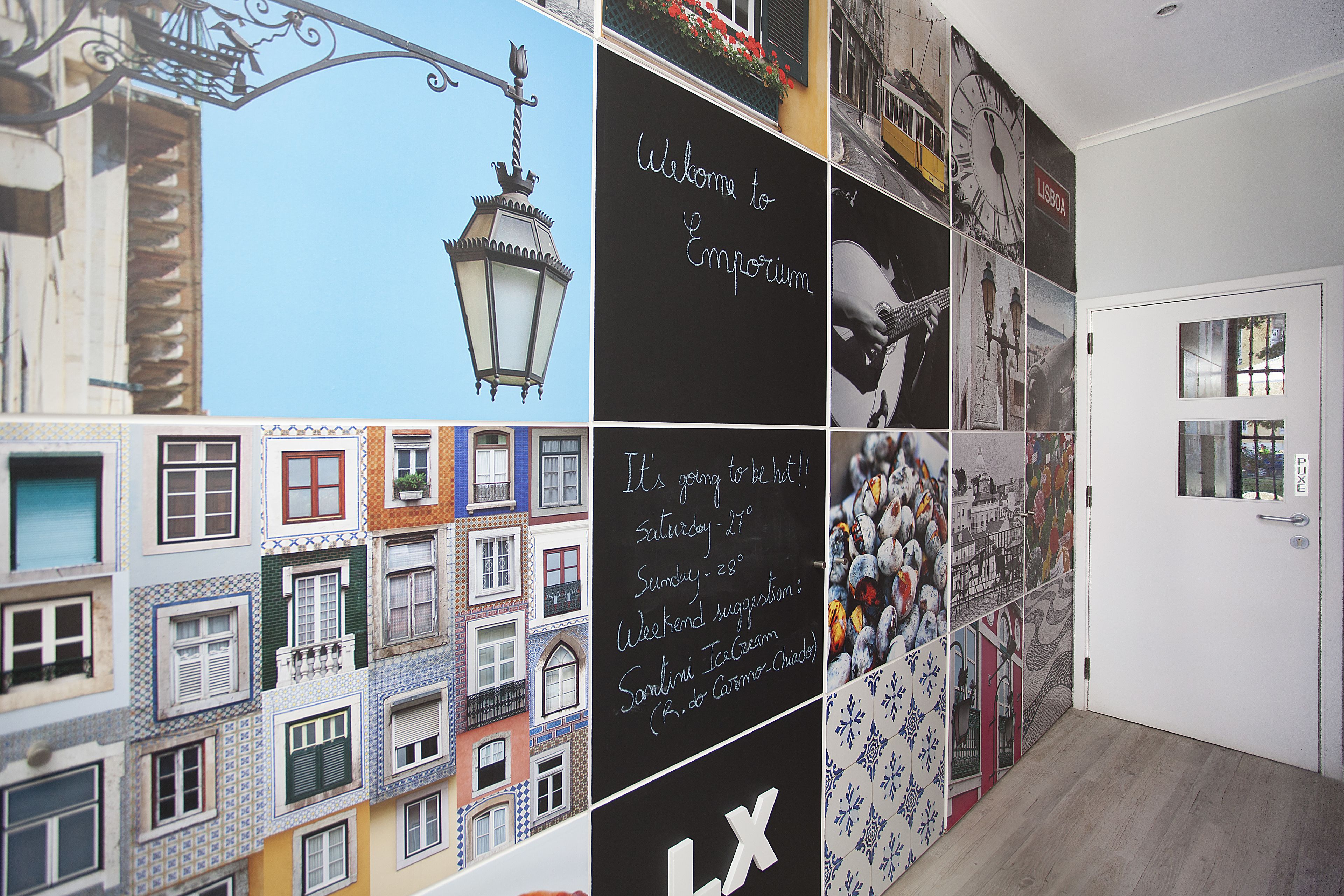 A wall with various photographs and text, including a welcome sign and temperature information.
