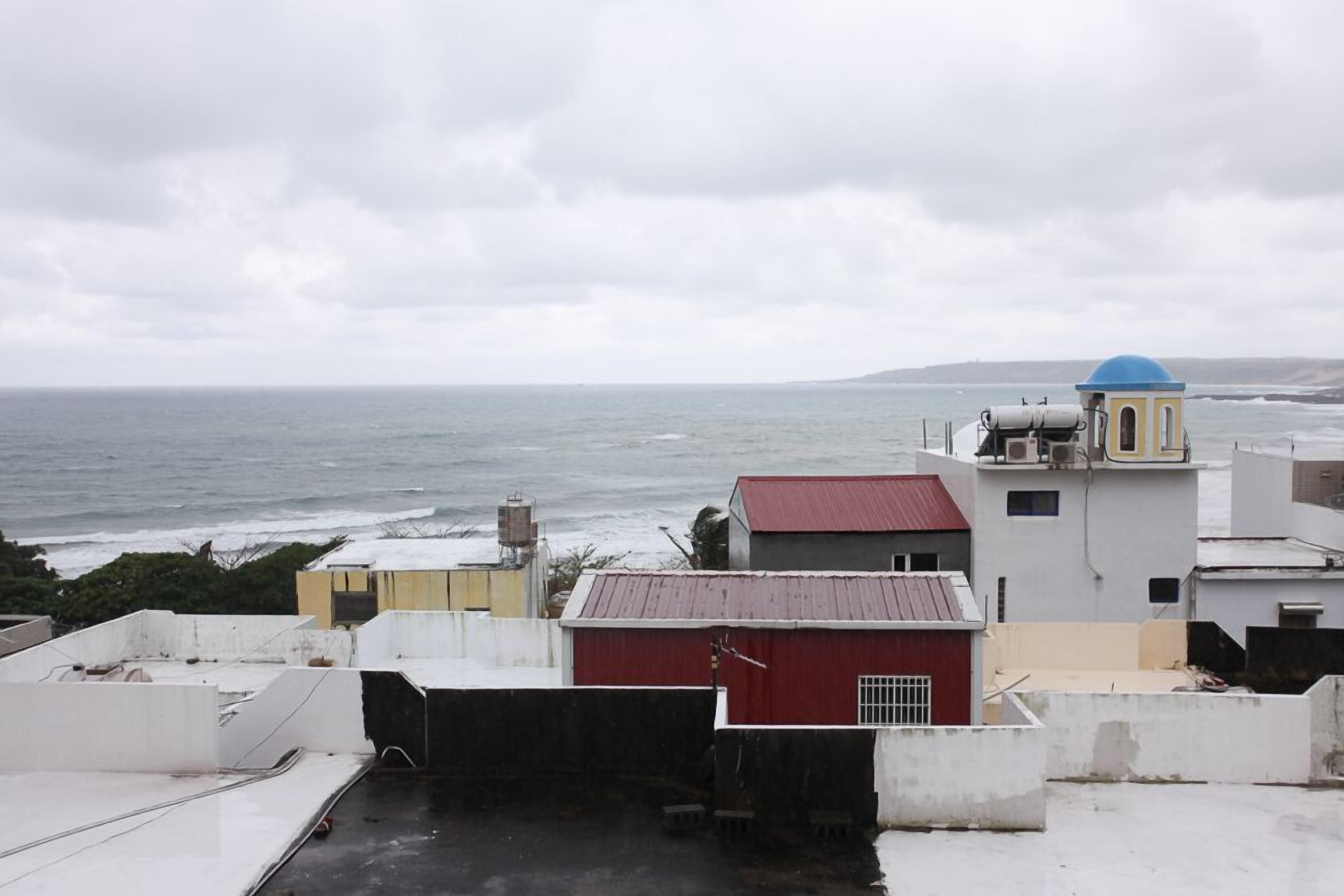 A coastal view with buildings and a sea in the background.