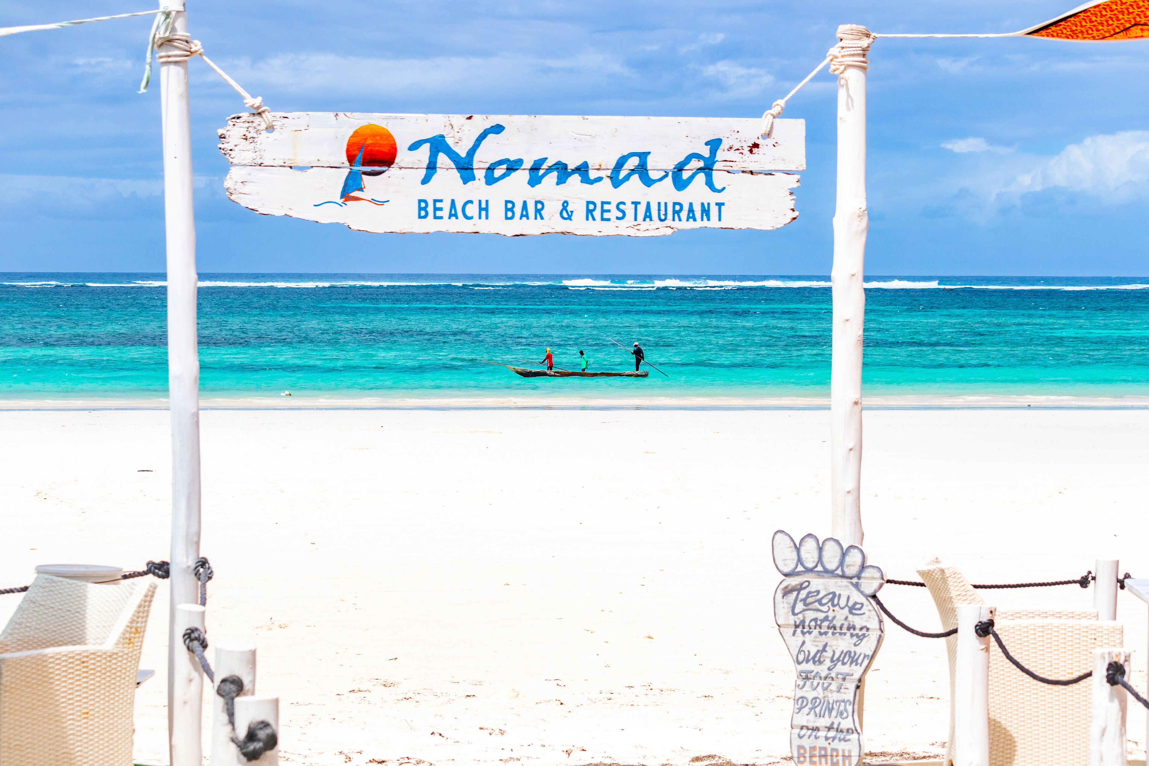 A beach bar and restaurant sign with a logo and name.