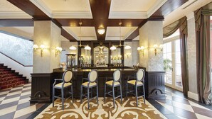 A bar area with a checkered floor, bar stools, and wall-mounted lighting. -  PortAventura Hotel Lucy's Mansion -Includes unlimited access & Express wristband to PortAventura Park & Ferrari Land (Vila-Seca)