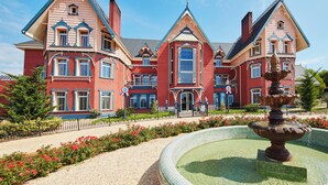 A large, ornate building with multiple gabled roofs and a central entrance. -  PortAventura Hotel Lucy's Mansion -Includes unlimited access & Express wristband to PortAventura Park & Ferrari Land (Vila-Seca)