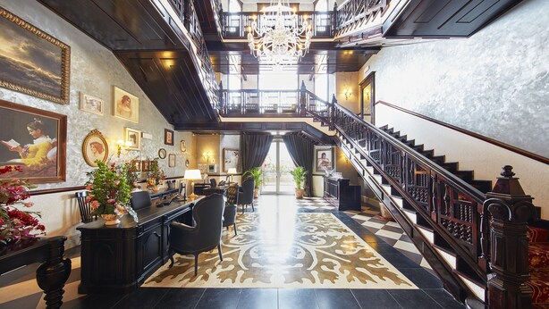 A grand lobby with a chandelier, a staircase, and a reception desk. -  PortAventura Hotel Lucy's Mansion -Includes unlimited access & Express wristband to PortAventura Park & Ferrari Land (Vila-Seca)