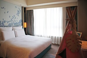 A hotel room with a large bed, a wall with a blue abstract design, a window with curtains, and a chair. - Pullman Taiyuan (Taiyuan)