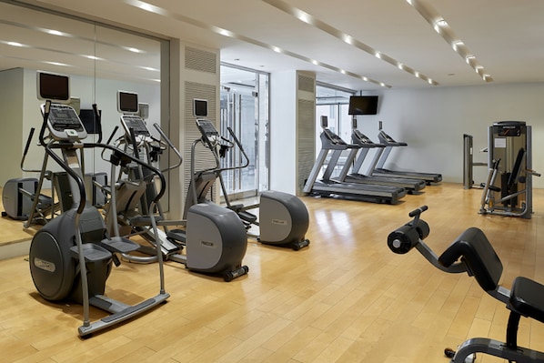 A gym with various exercise equipment, including treadmills and elliptical machines. - Pullman Taiyuan (Taiyuan)