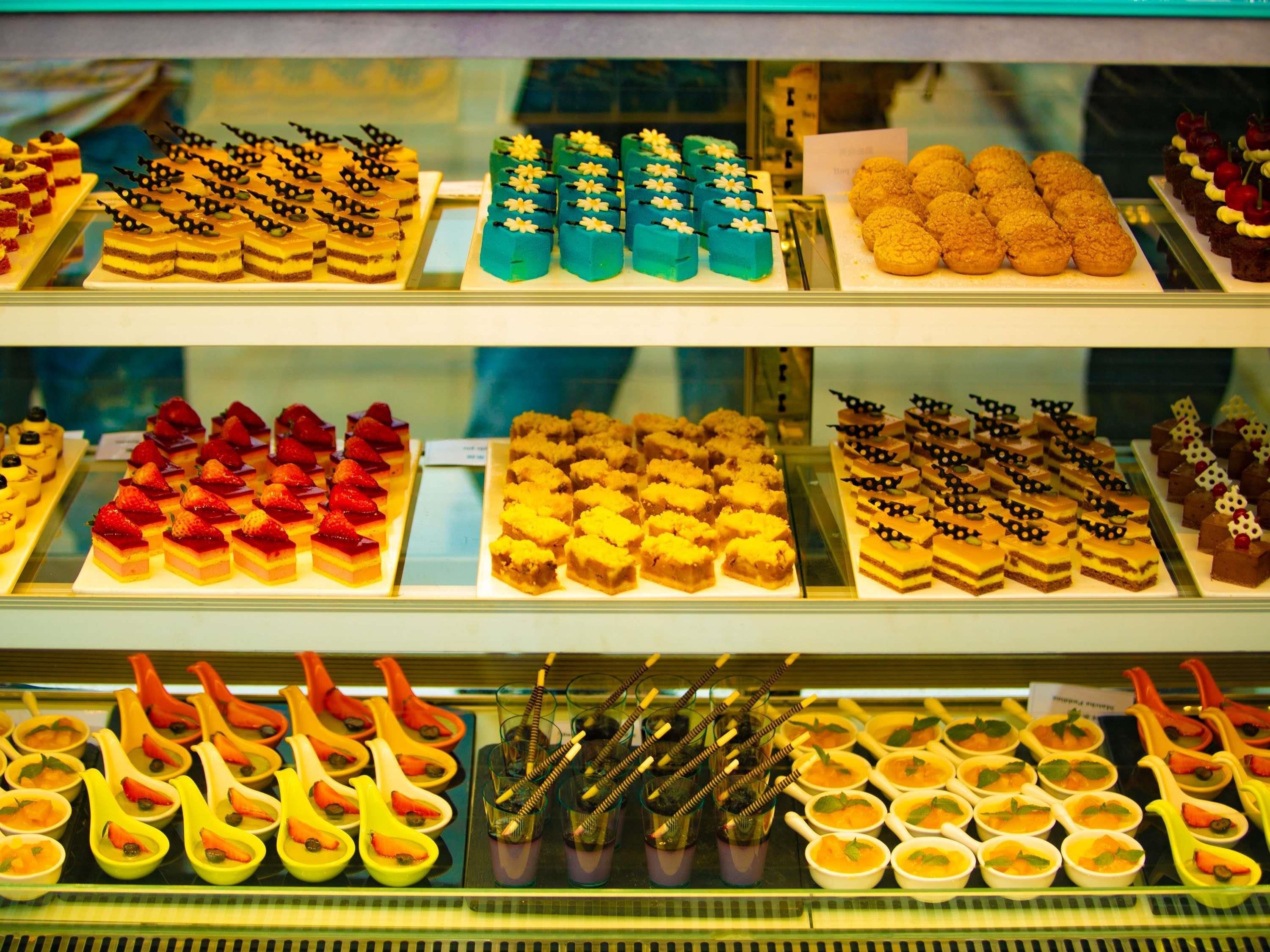 A display case with various desserts and drinks.