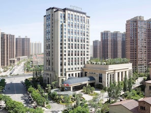 A high-rise hotel with a modern design, featuring a prominent entrance and a rooftop garden. - Pullman Taiyuan (Taiyuan)