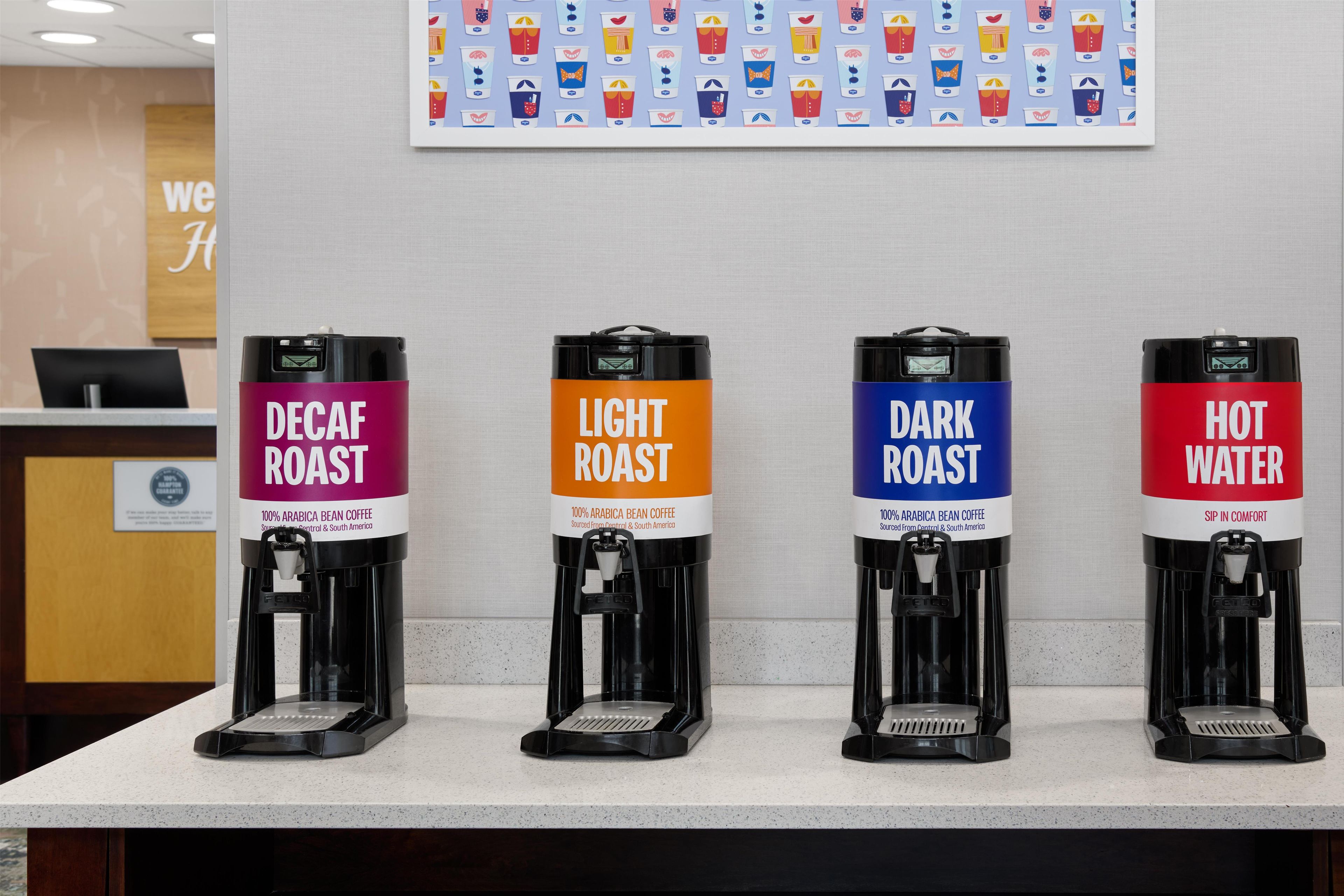 Four coffee dispensers labeled Decaf Roast, Light Roast, Dark Roast, and Hot Water, each with a coffee maker.