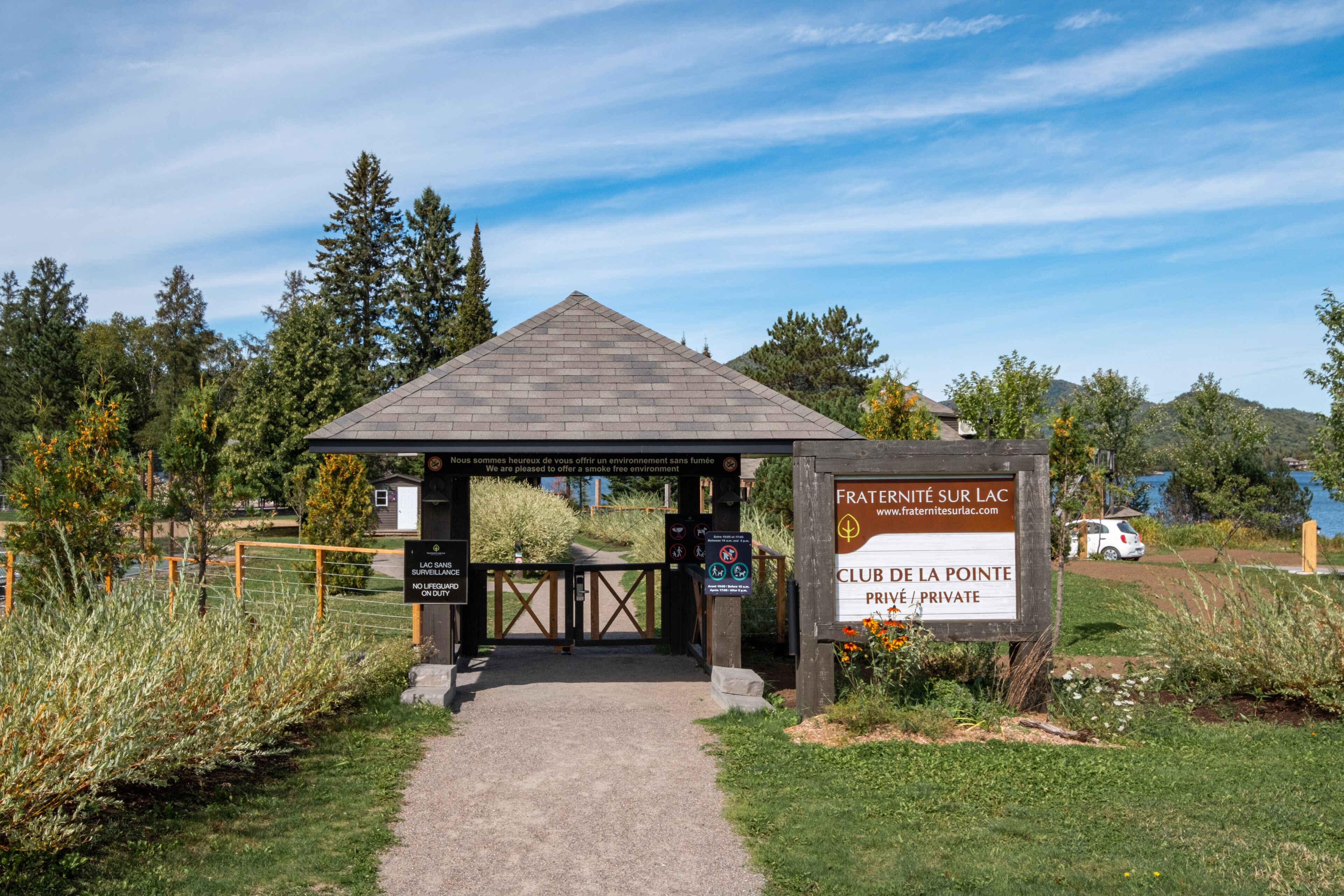 A gated entrance to a private club with a sign indicating it is a smoke-free environment.