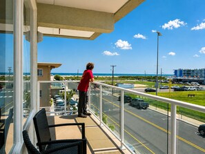 A balcony with a view of a parking lot and a building across the street. - Crystal Beach Motor Inn (Wildwood Crest)