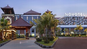 A hotel with a traditional and modern architectural style, featuring a prominent 'NOVOTEL' sign. - Novotel Bali Ngurah Rai Airport (Tuban)