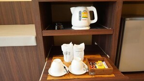 A kitchenette area with a coffee maker, tea pots, and a tray with condiments. - Golden Moon Aonang (Krabi)