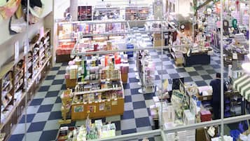 A spacious store with a checkered floor, various shelves stocked with goods, and a central aisle for easy navigation.