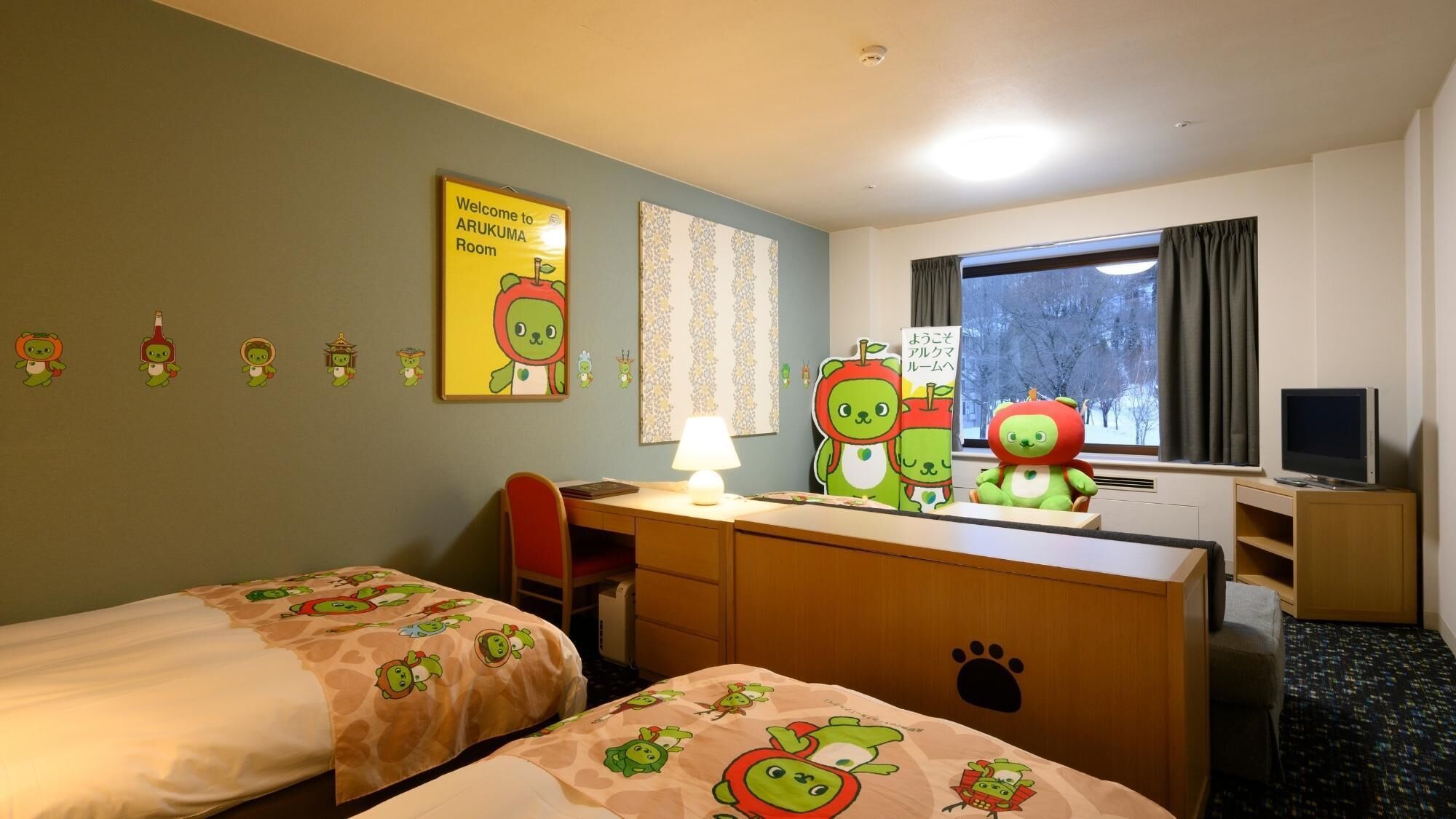 A hotel room with two beds, a desk with a lamp, a TV, and a window with a view of trees.
