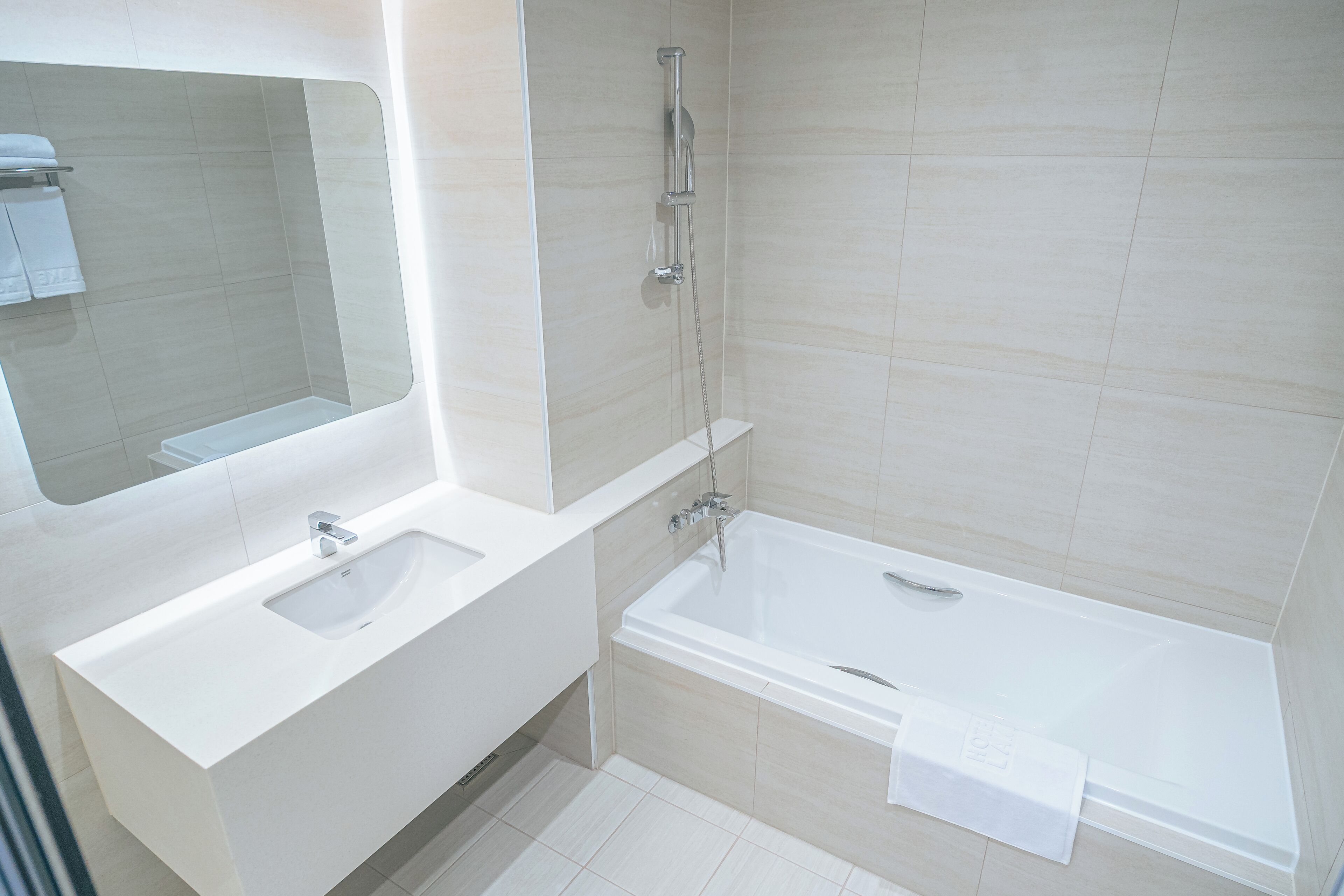 deluxe twin room | bathroom | separate bathtub and shower, deep-soaking bathtub, hair dryer, slippers