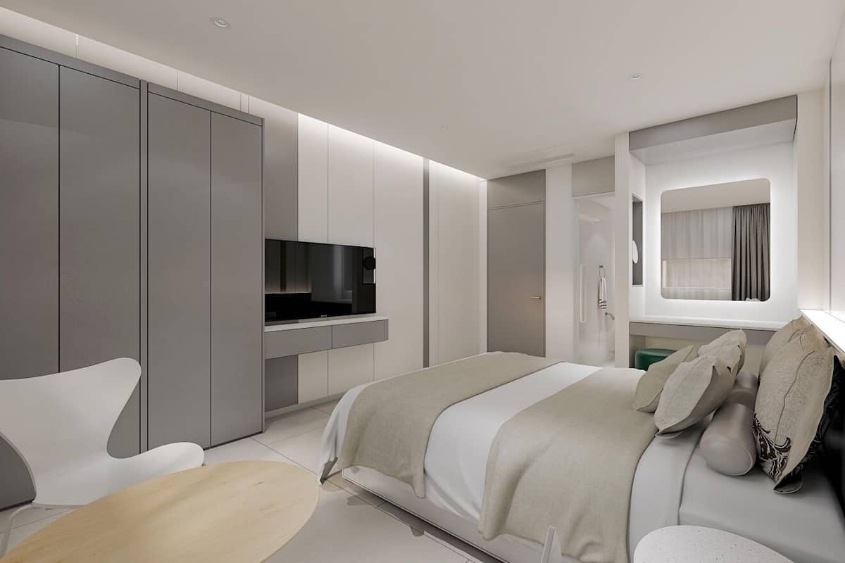 A modern bedroom with a bed, a TV, and a large wardrobe.