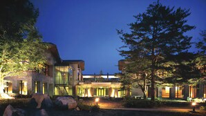 A modern building with large windows and a well-lit entrance. - Hotel Harvest Nasu (Nasu)