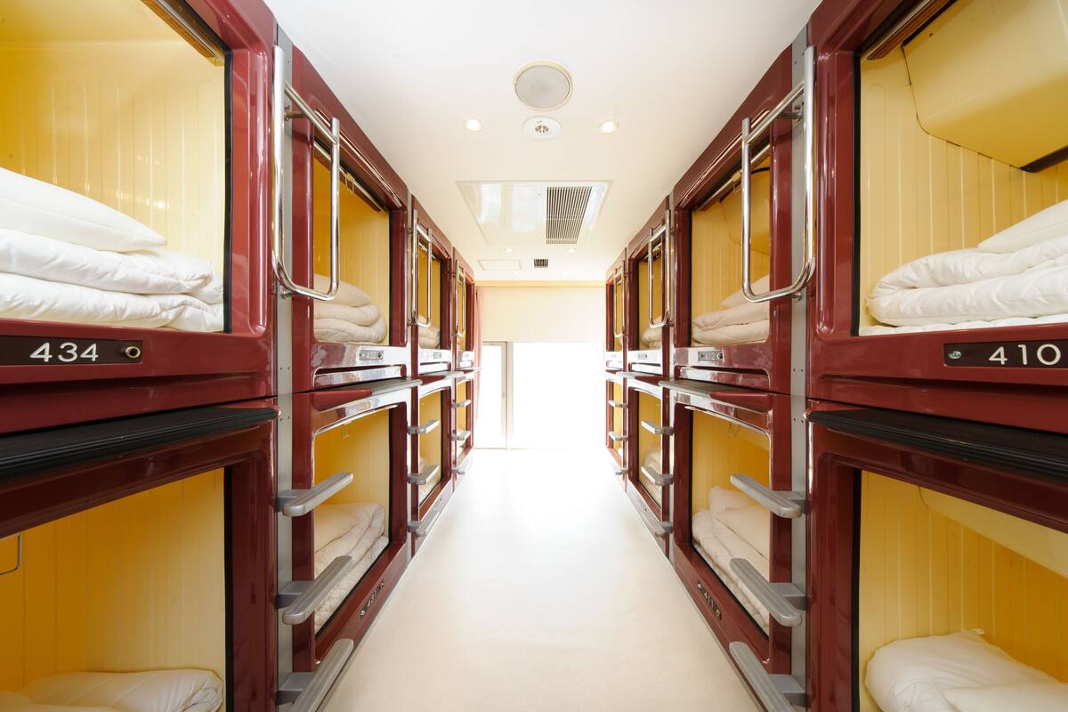 A corridor with bunk beds, each labeled with a number.