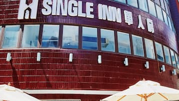 Welcome to Single Inn, where guests can relax in outdoor seating areas with tables and chairs.