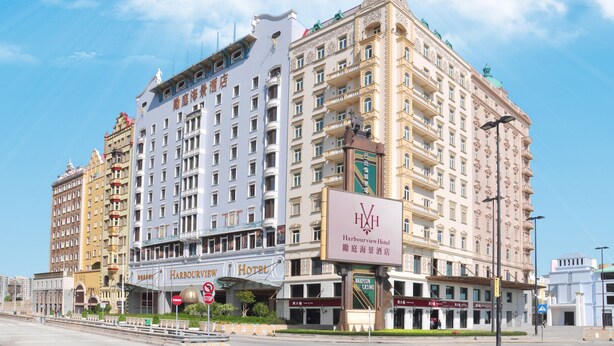 A multi-story hotel with a prominent 'Harbourview Hotel' sign, featuring a classic architectural style with ornate balconies and a green dome on top. - Harbourview Hotel Macau (Macau)