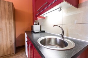 Estúdio standard, sacada | Cozinha americana privada | Cooktop, torradeira, produtos de limpeza